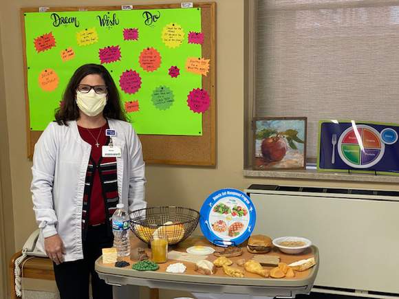 A Nutrition Services team member providing health education.