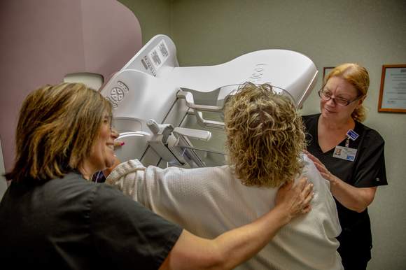 Kathy Lashley, a Mammographer Technologist at Froedtert South, performs a routine mammogram for a female patient.