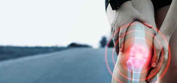 running candidate grasping knee- showing x-ray type bone image